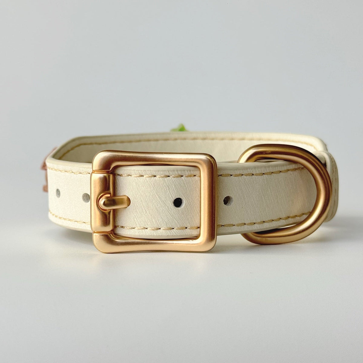 Close-up of cream faux leather pet collar with golden buckle, christmas tree and small house ornaments without bead chain | DIY Jade