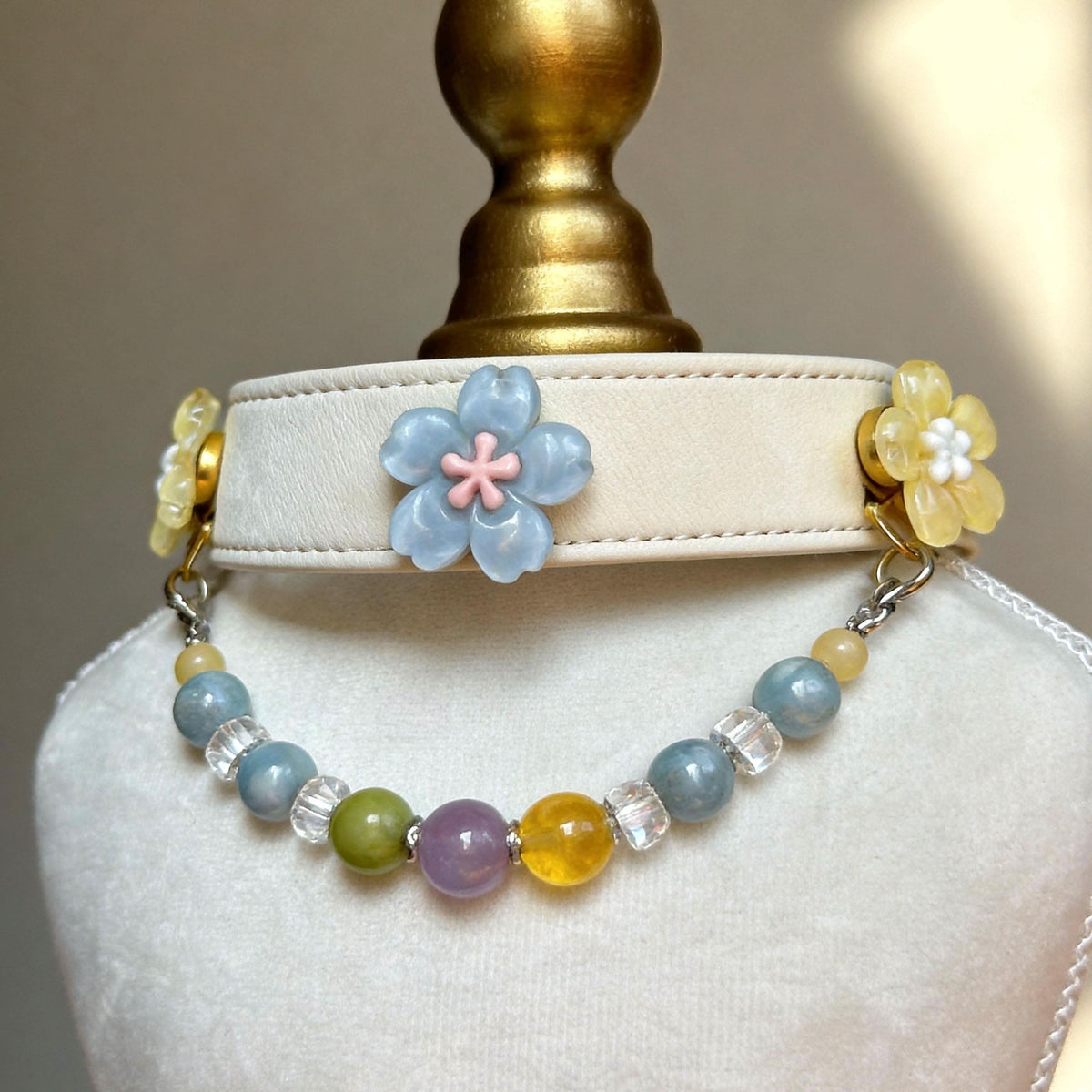 Mannequin bust showing cream leather pet collar with blue yellow flower accents and rainbow jade beads | DIY Jade