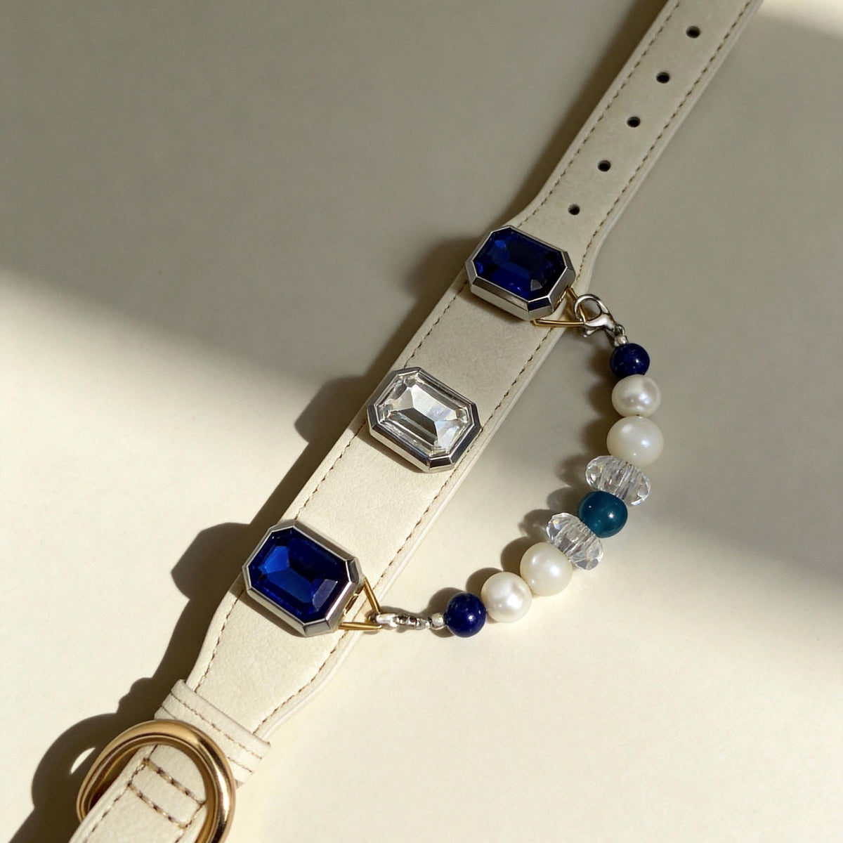 Flat lay shot of cream leather pet collar with sapphire and jade beads | DIY Jade