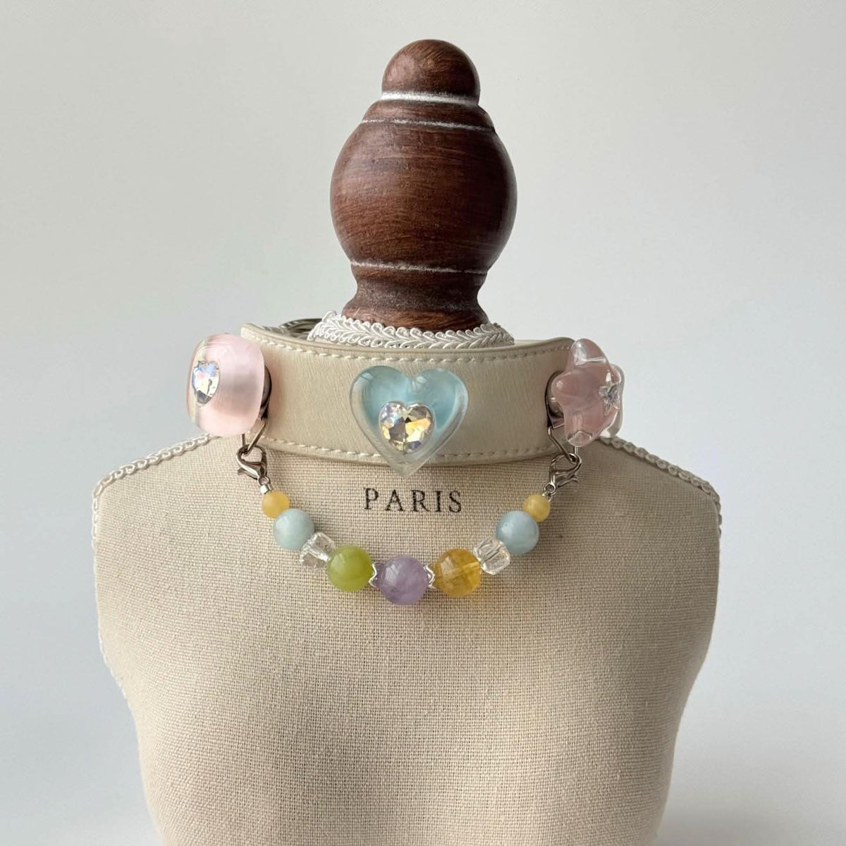 Cream pet collar with dog‑shape ornament and rainbow pastel bead chain display bust | DIY Jade