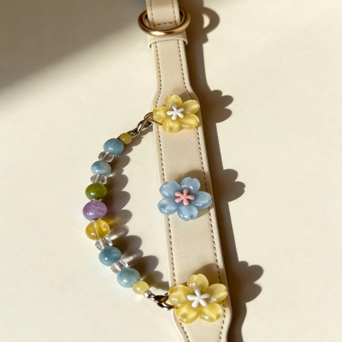 Curved display of cream leather pet collar with blue yellow sakura and rainbow jade beads | DIY Jade