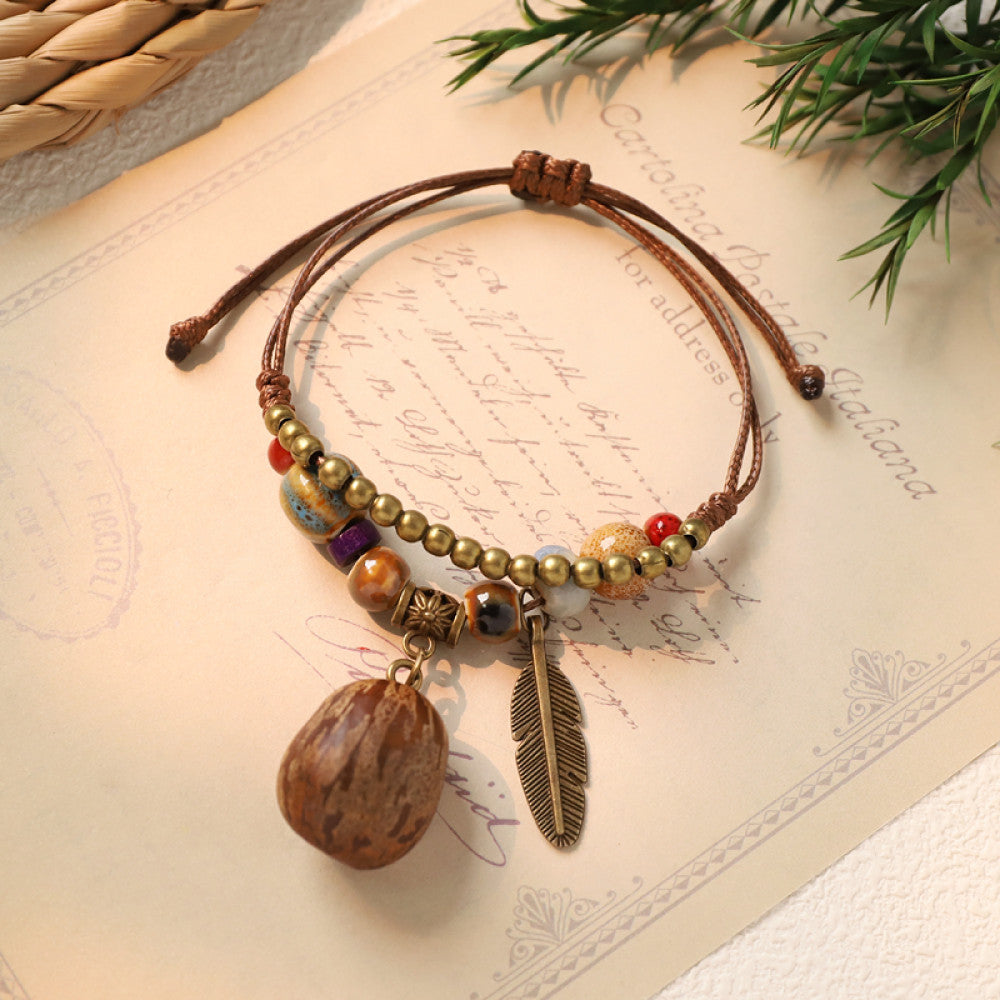 Ethnic bracelet with dark brown nut charm and feather | DIY Jade
