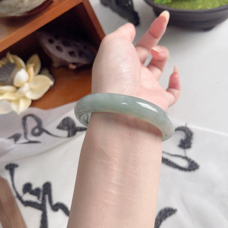 Natural dark green oily jadeite bangle worn on wrist, close-up fit view | DIY Jade