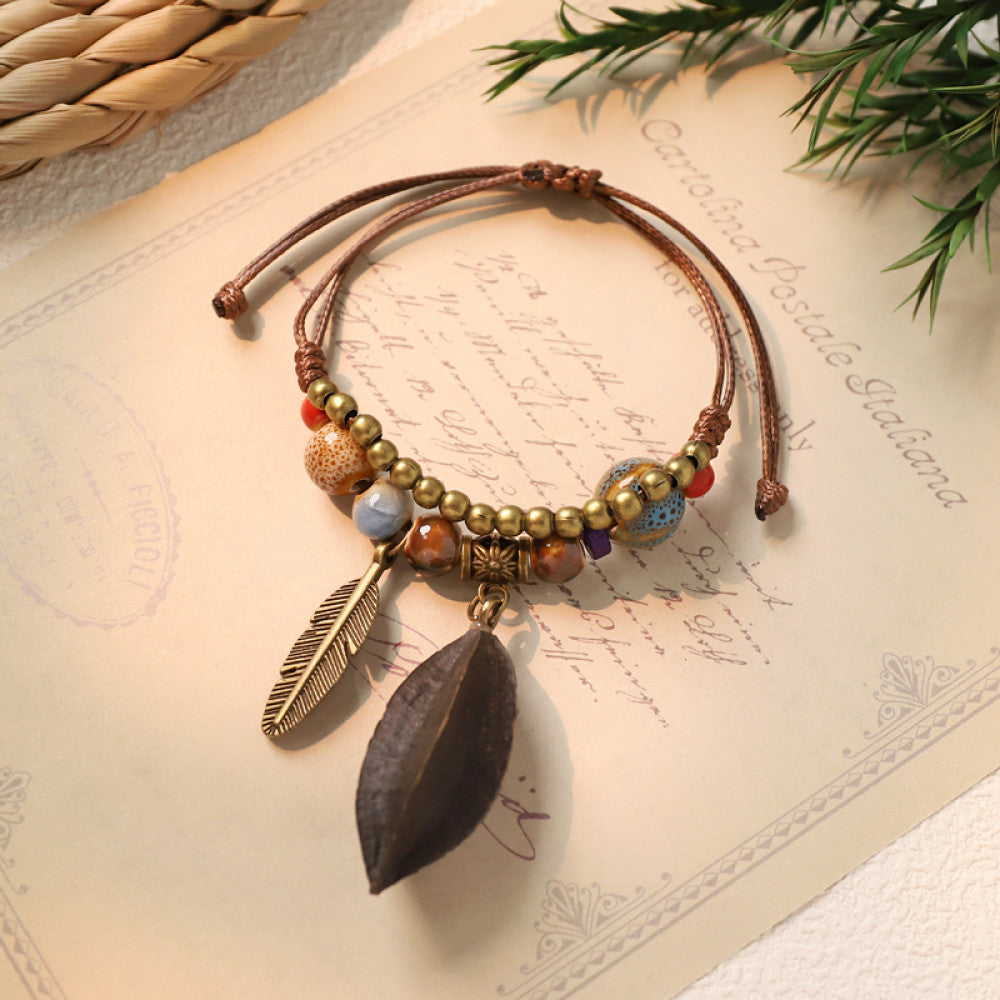 Ethnic bracelet with dark seed charm and feather pendant | DIY Jade
