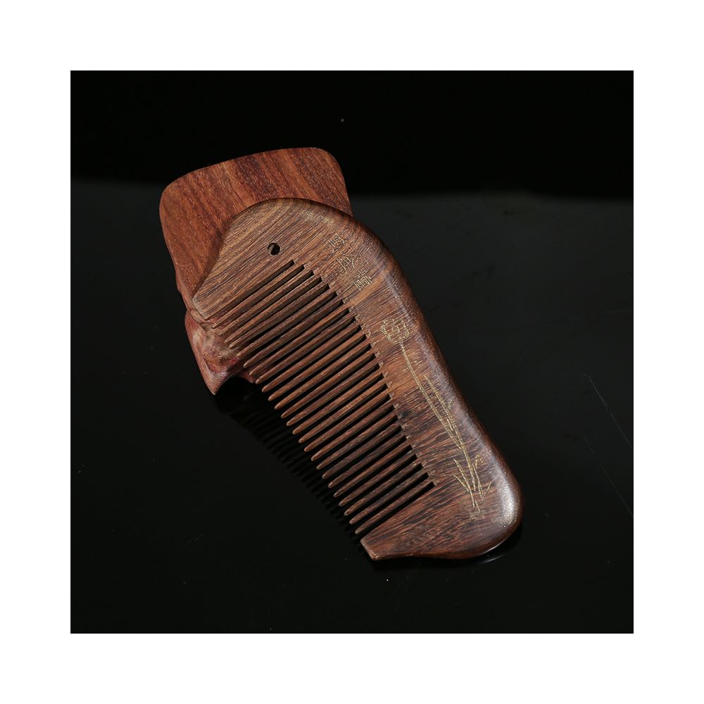 Closeup of engraved wooden hair comb
