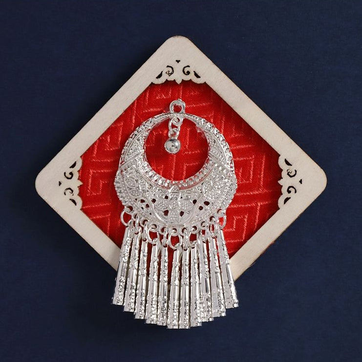 Red diamond‑shaped fridge magnet, replica Miao silver crescent necklace with tassels