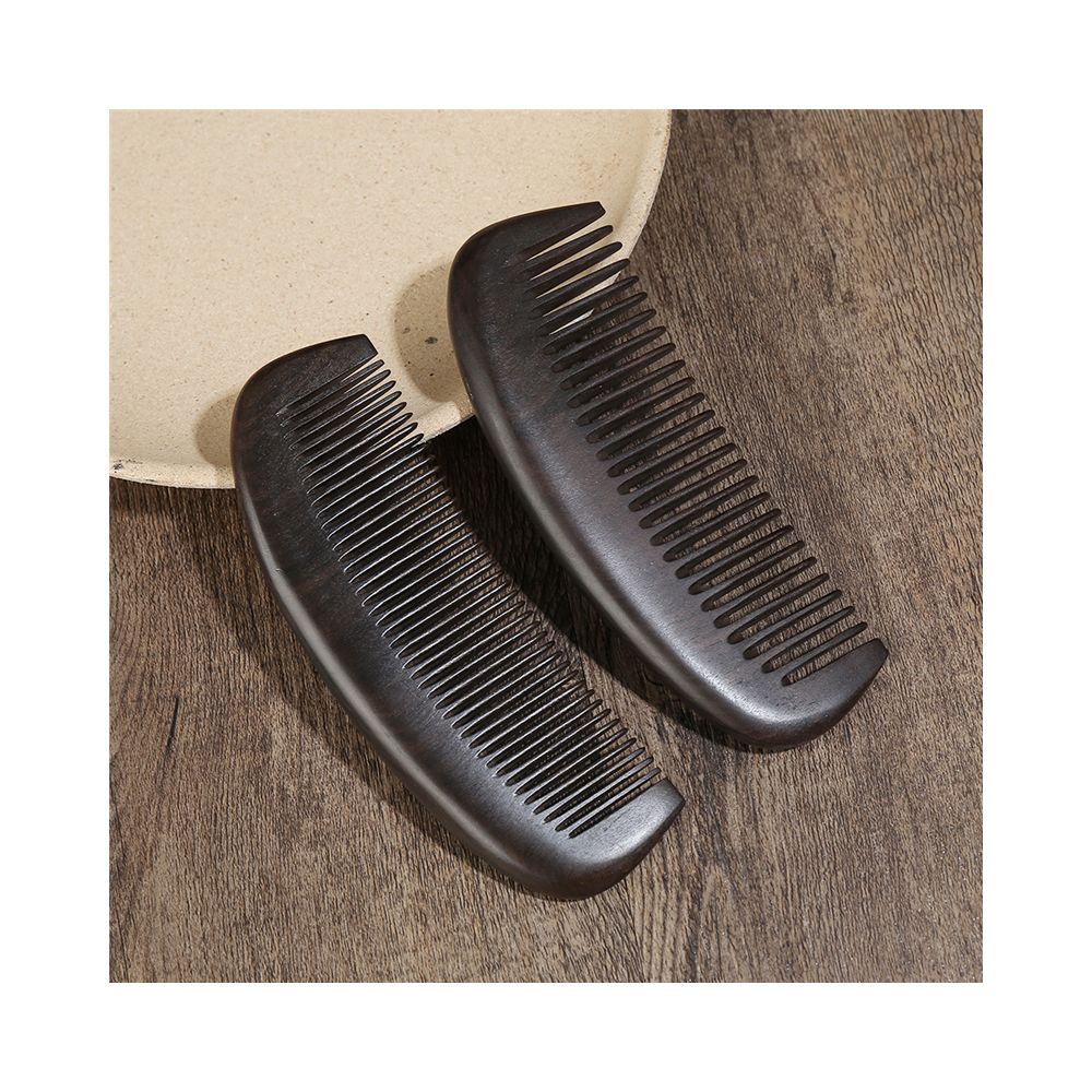 Closeup of two ebony wood hair combs