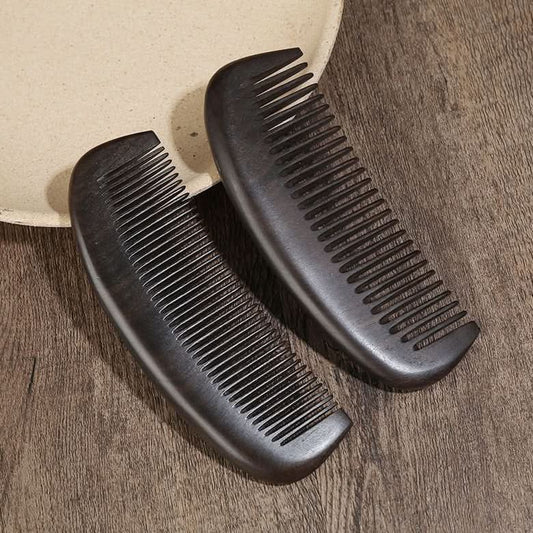 Closeup of two ebony wood hair combs