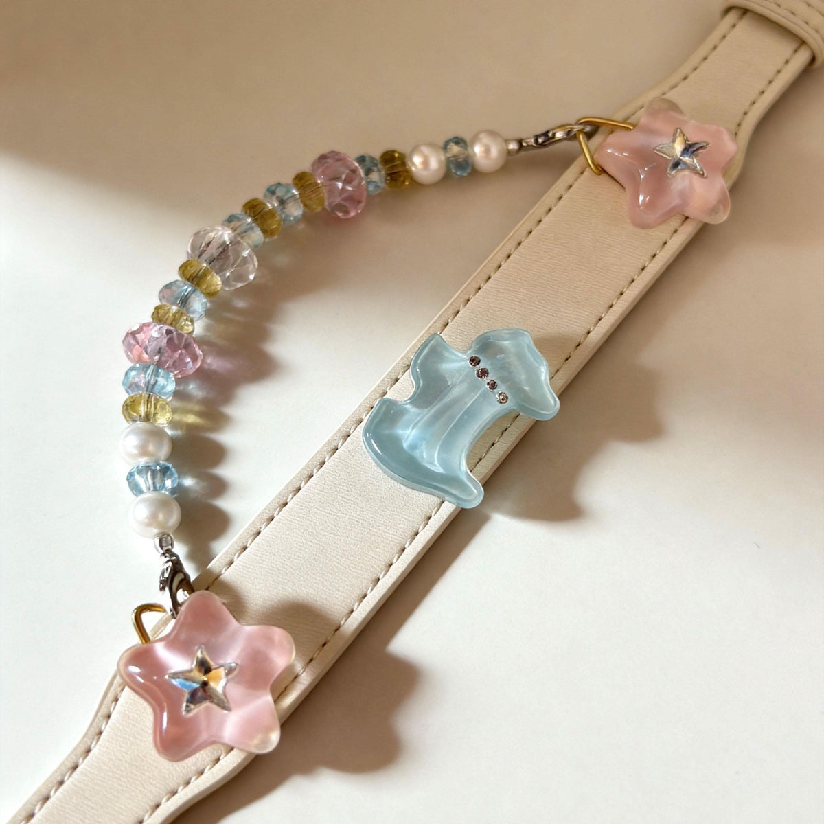 Flat lay view of cream pet collar with blue bow charm and mixed jade beads | DIY Jade