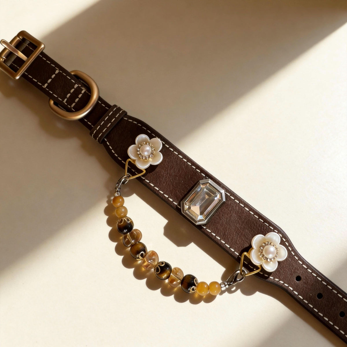 Flat lay view of leather pet collar with crystal decor and tiger eye jade bead chain | DIY Jade