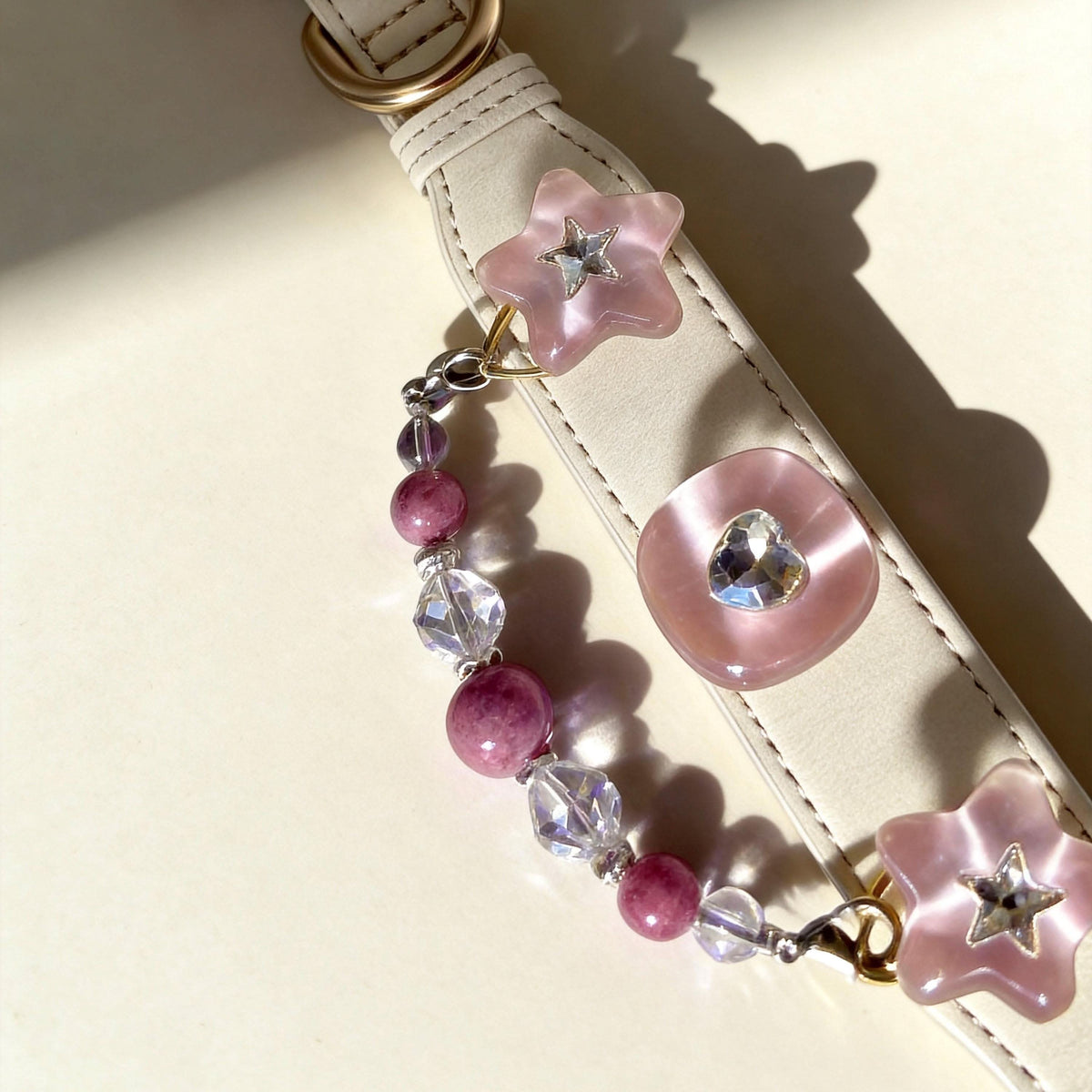 Top down flatlay of cream pet collar with heart ornament and mixed pink jade beads | DIY Jade