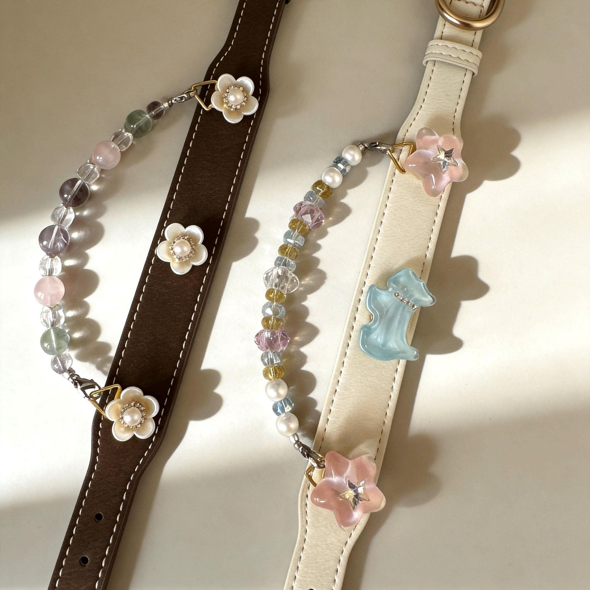 Flat lay view of brown and cream leather pet collars with flower accents and pastel jade beads | DIY Jade