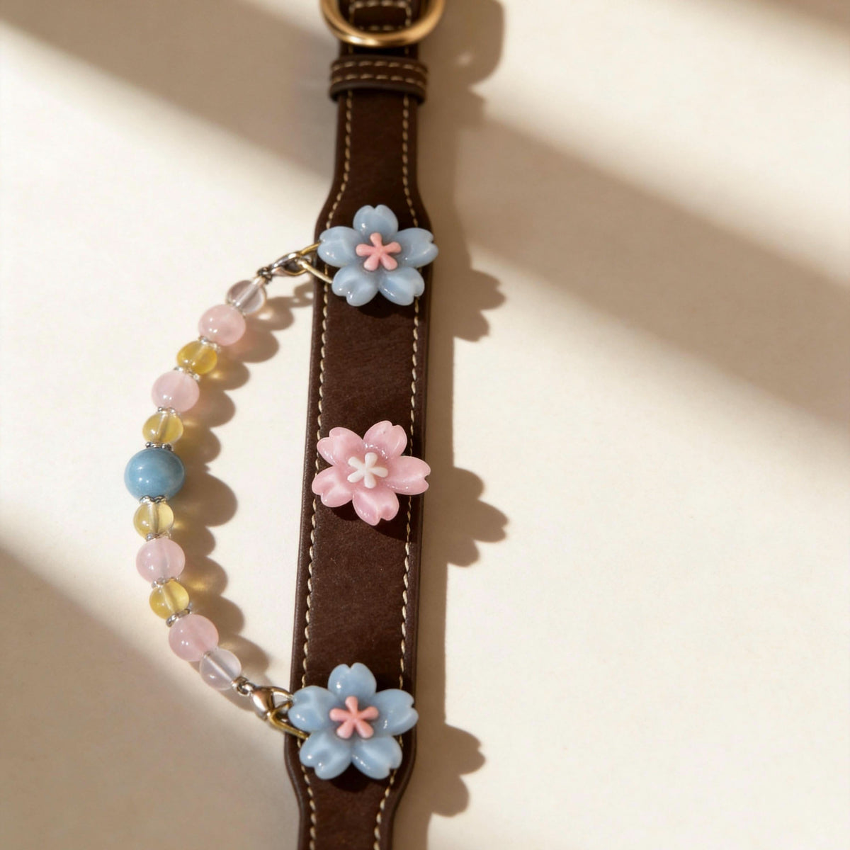 Flat lay shot of brown leather pet collar with sakura decor and mixed jade beads | DIY Jade