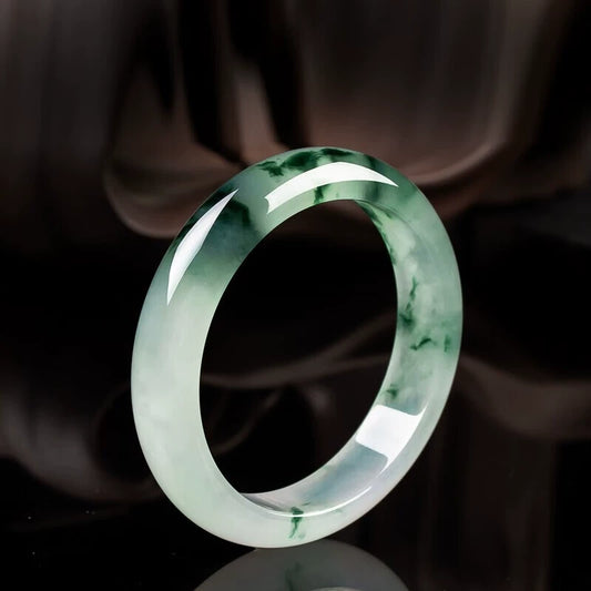 Green floating flower jadeite bangle side view, showing glossy finish and natural texture | DIY Jade
