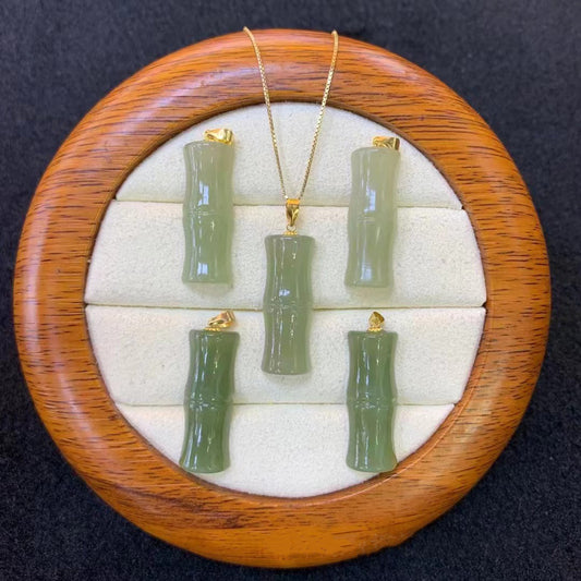 Green jade bamboo-shaped pendants with gold bails, bulk display in wooden tray | DIY Jade