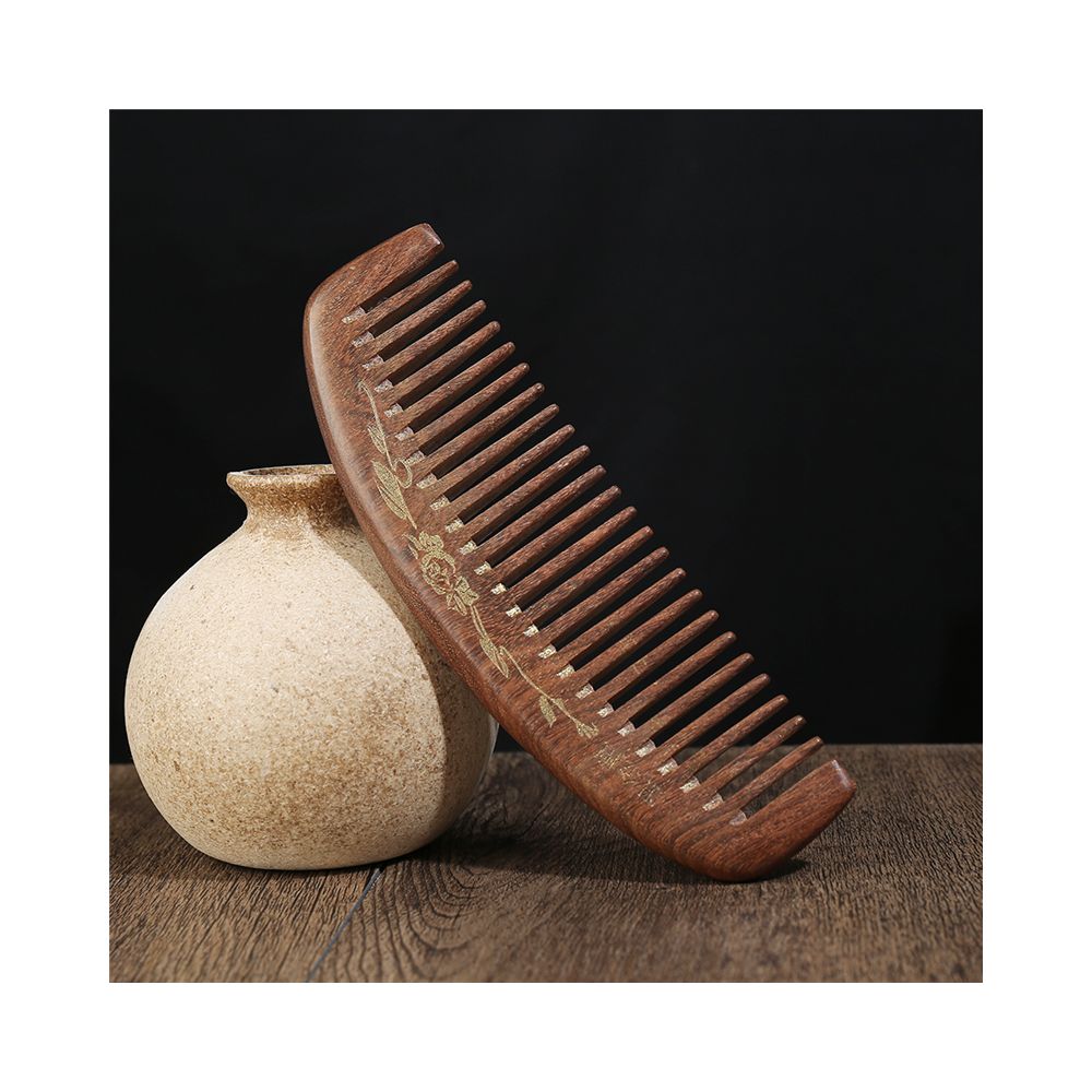 Hand carved wooden hair comb with floral engraving