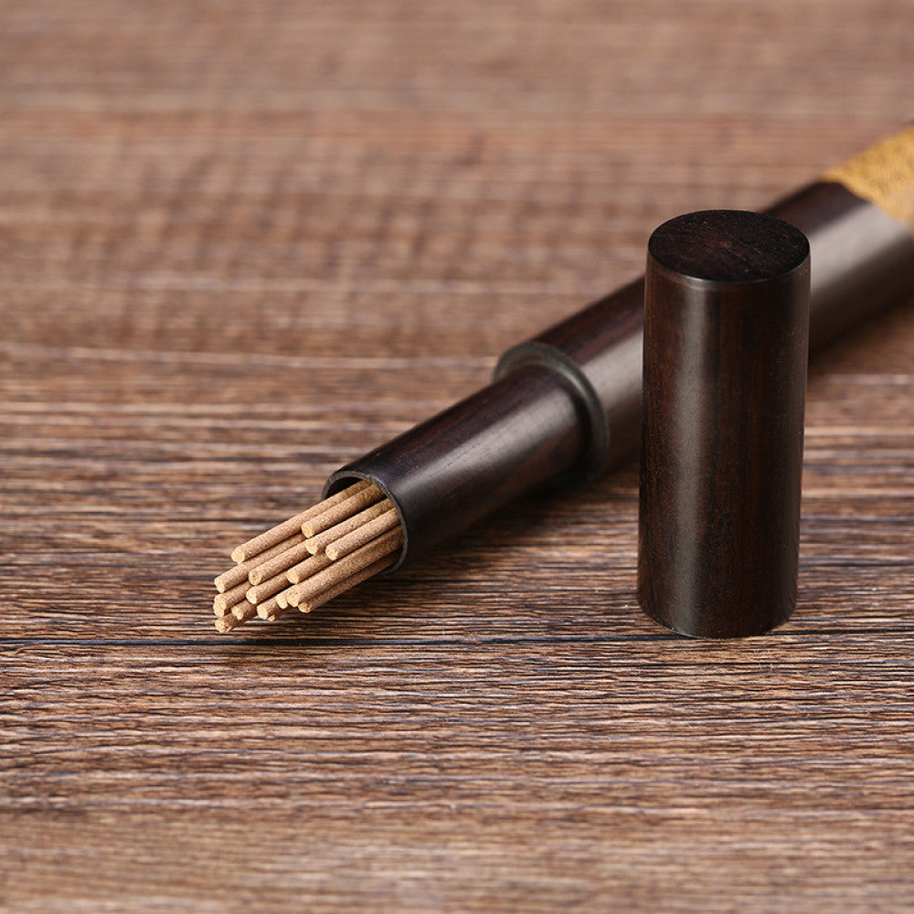 Handcrafted ebony incense tube with copper inlay detail