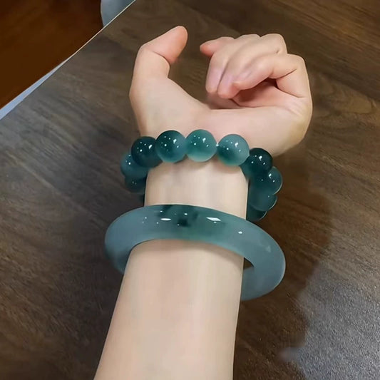 Natural icy blue floating flower jadeite bangle paired with matching beaded bracelet, worn on wrist | DIY Jade