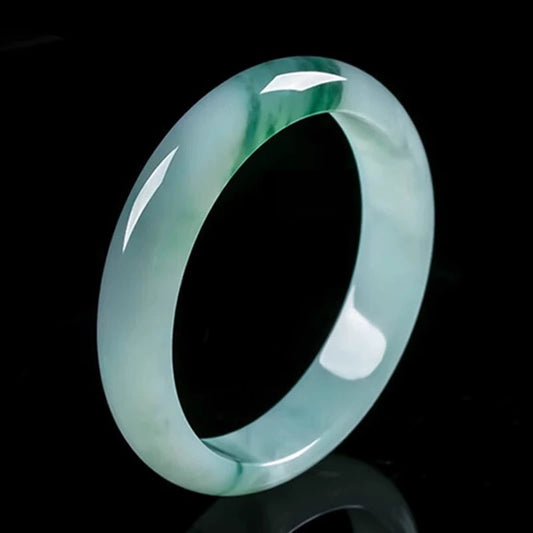 Icy pale green jade bangle with natural green veins, glossy studio shot | DIY Jade