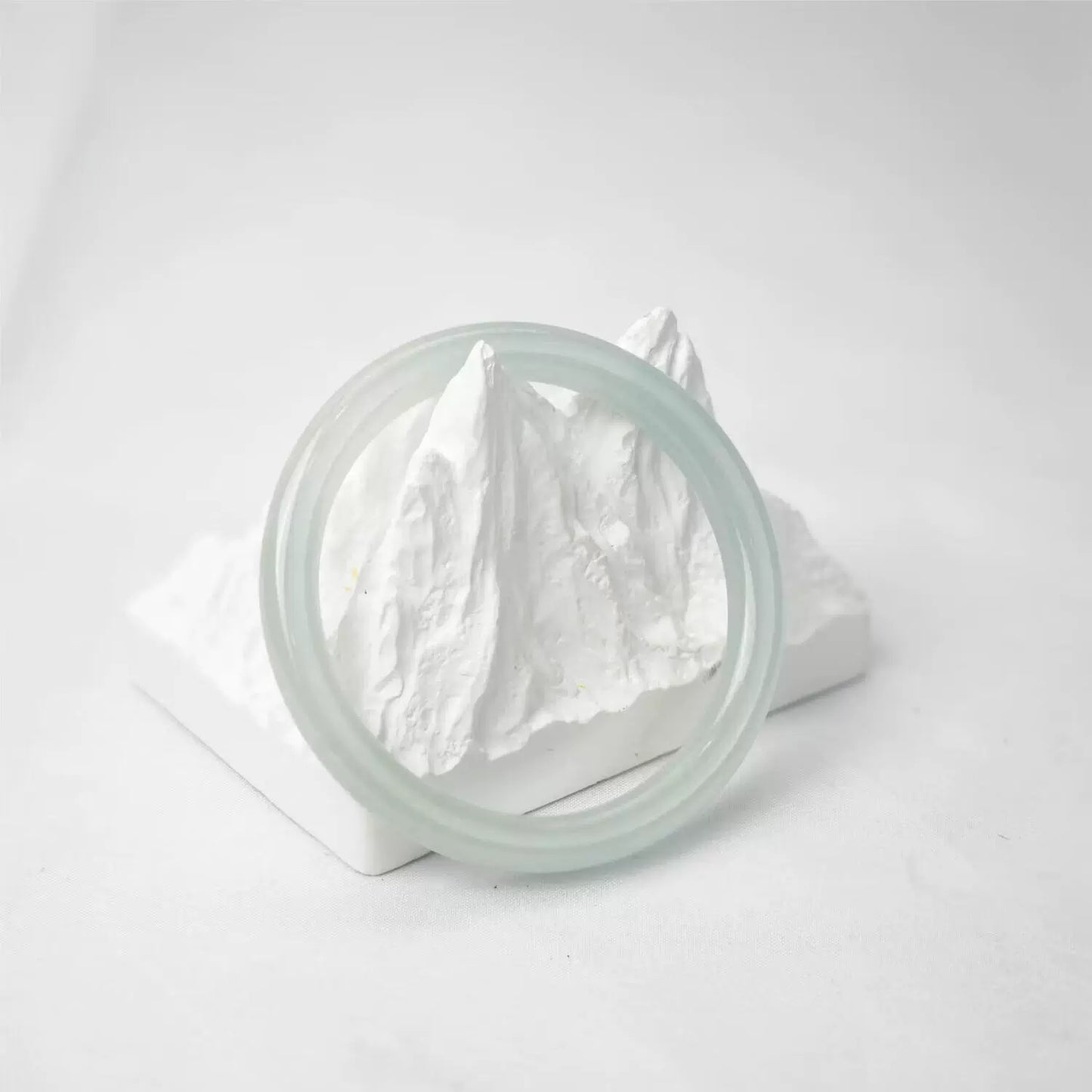 Natural icy pale green round jade bangle on mountain display, minimalist studio shot | DIY Jade