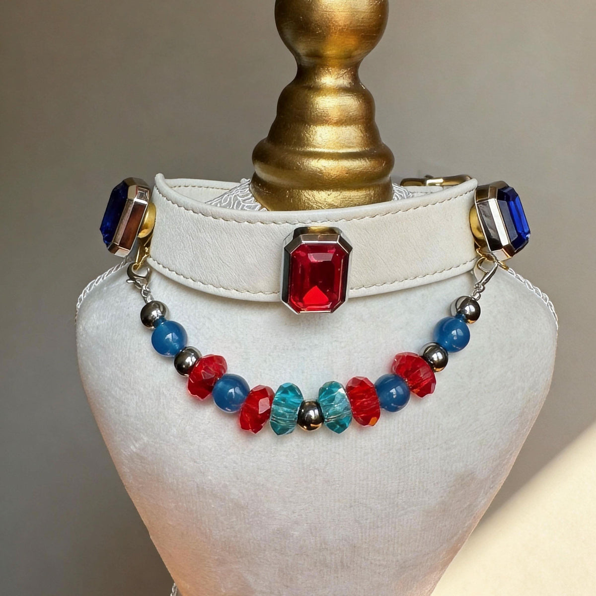 Off-white leather pet collar closeup, decorated with large red square gem and multi-color turquoise jade bead chain | DIY Jade