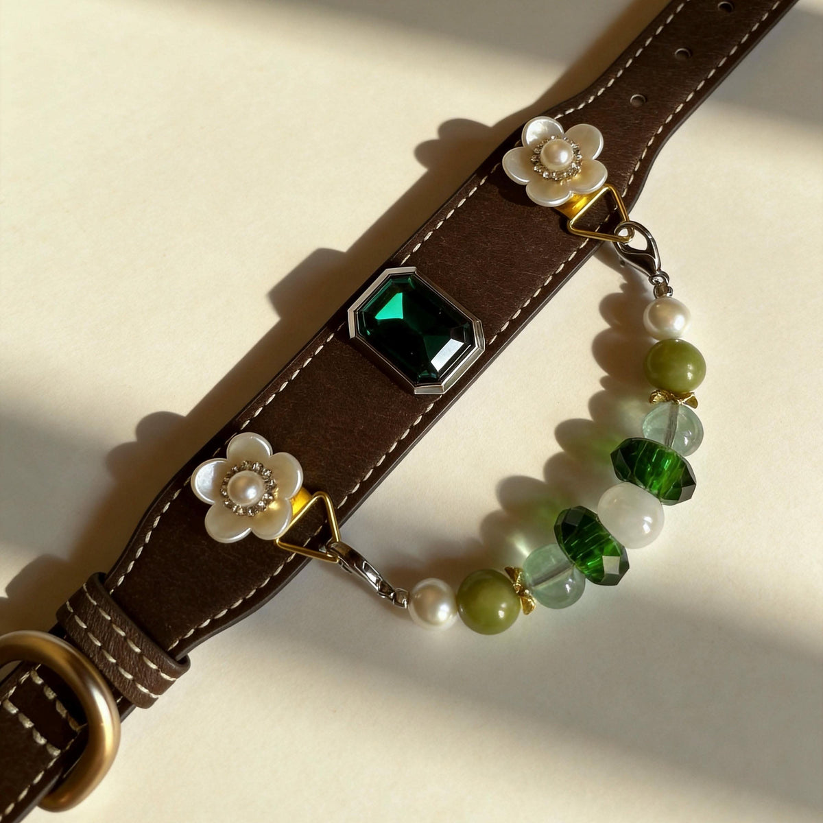 Flat lay view of brown leather pet collar with flower decor and jade beads | DIY Jade