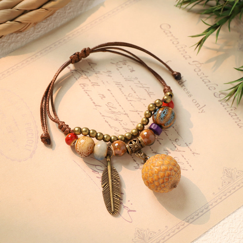 Boho bracelet with light brown bead charm and feather | DIY Jade
