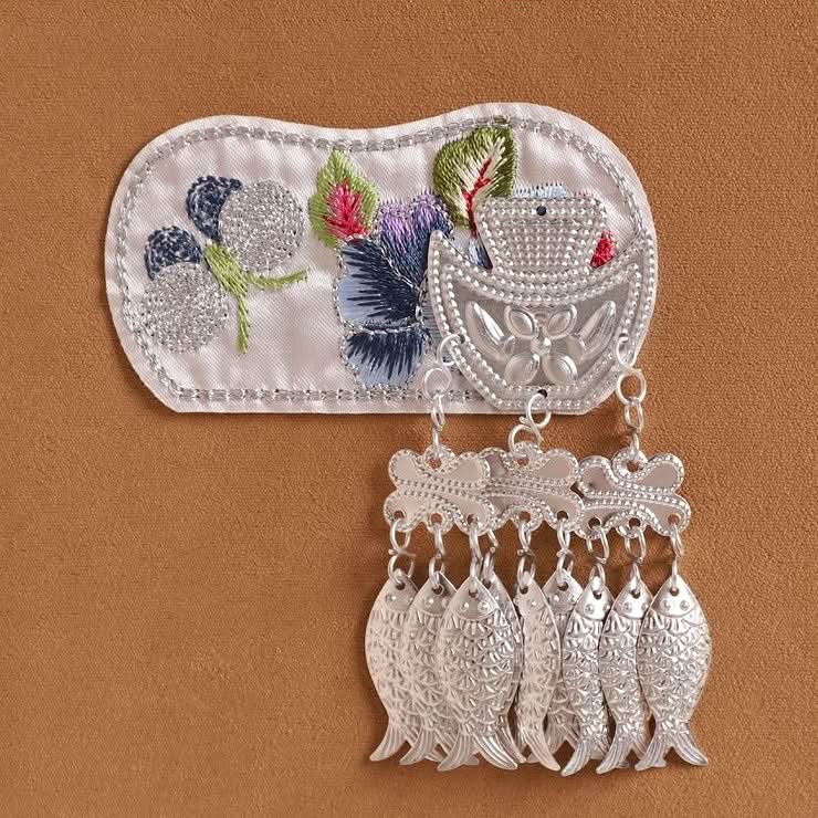 Soft‑color floral embroidery patch, hanging layered silver tassel trims, costume accessory
