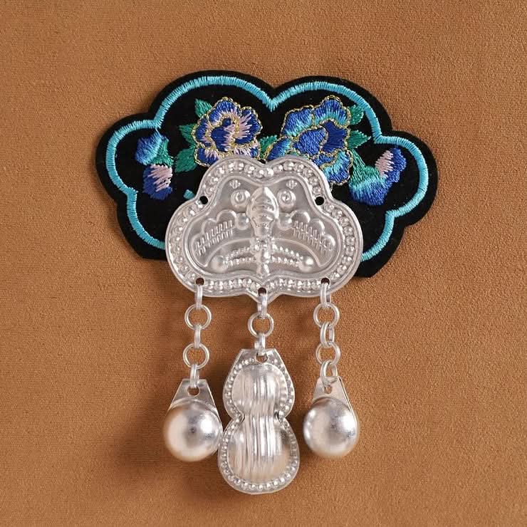 Ethnic costume applique, floral embroidery paired with dual pearl‑silver drop charms