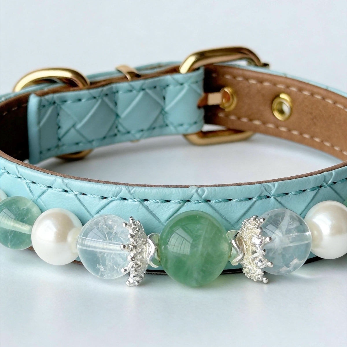 Close-up of mint blue quilted faux leather pet collar with green gem and pearl beads | DIY Jade