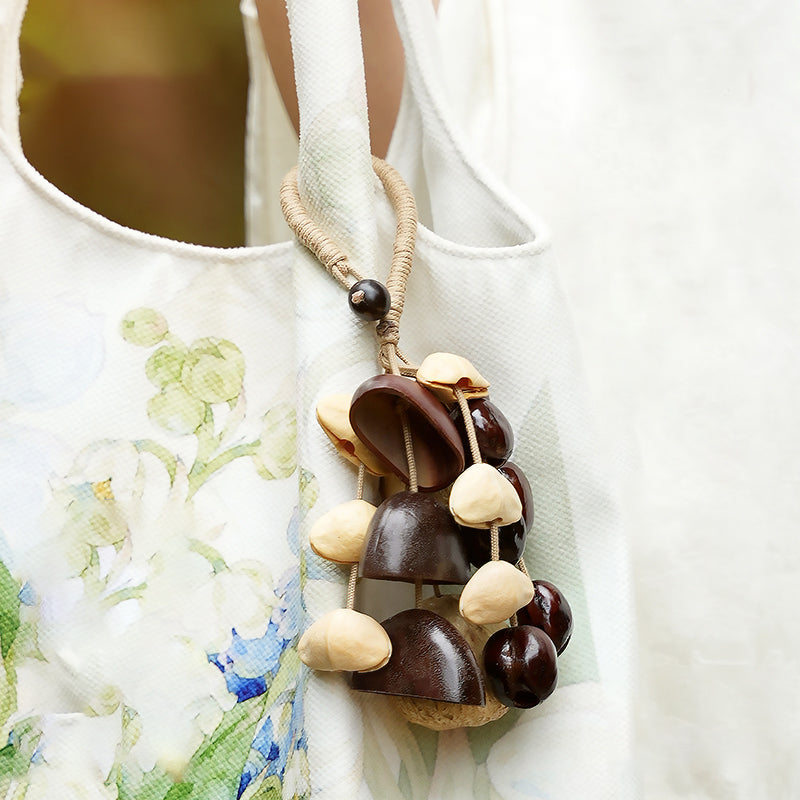 Mixed nut seed pod pendant hanging on cream canvas tote bag | DIY Jade