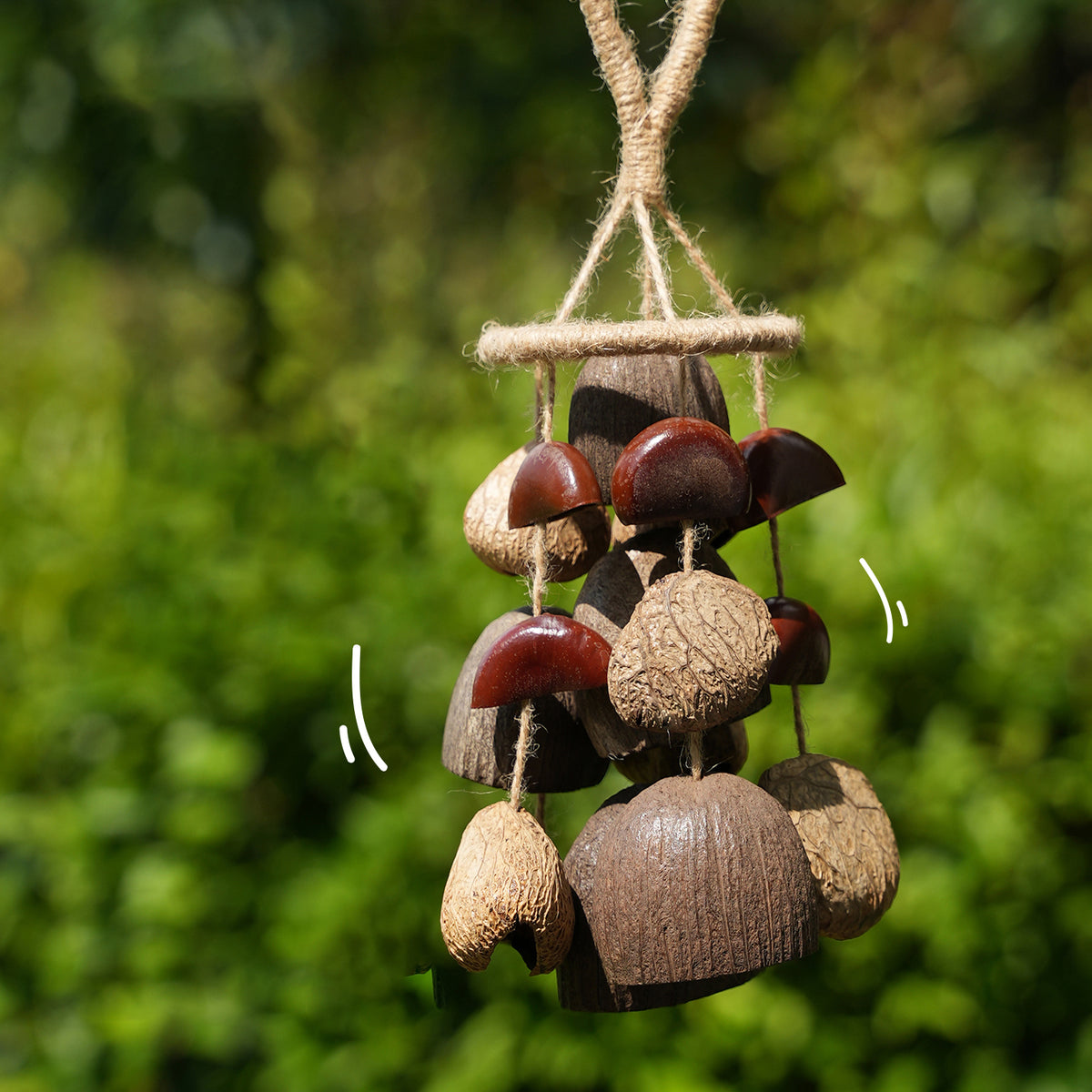 Multi‑variety seed pod wind chime hanging outdoors among lush green plants | DIY Jade