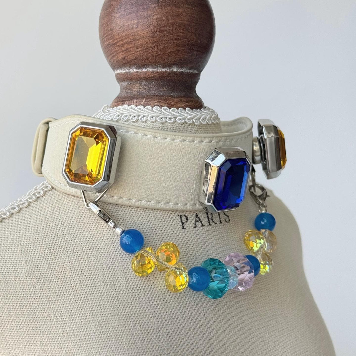 Multicolor crystal pet collar on display stand — side view on beige background|DIYJade