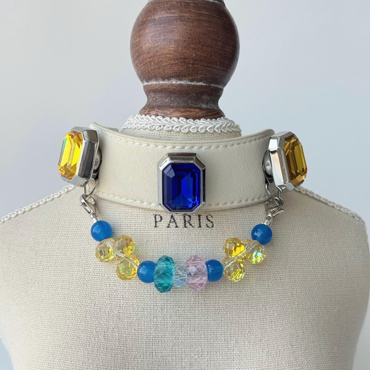 Multicolor crystal pet collar on display stand — blue yellow gemstone with beaded charm|DIYJade