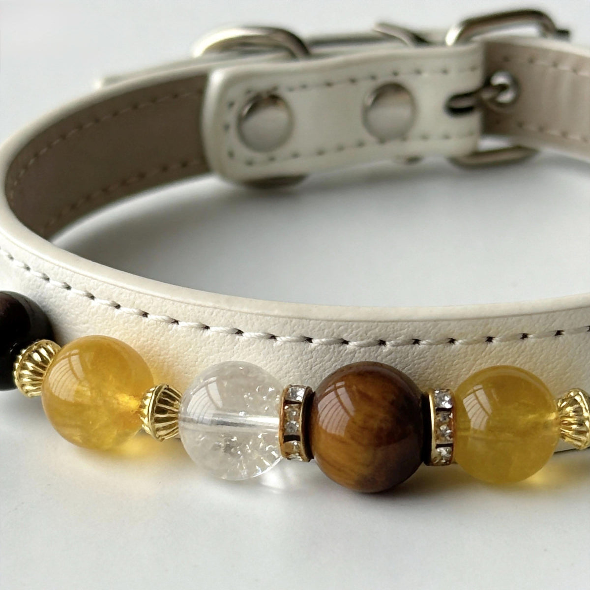 Close-up of off-white leather pet collar with yellow crystal and tiger eye gem beads | DIY Jade
