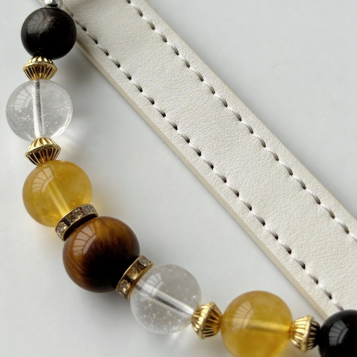 Side detail shot of off-white leather collar with yellow crystal and tiger eye beads | DIY Jade