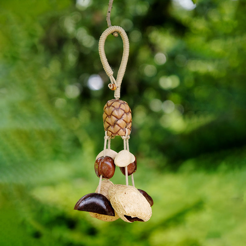 Mixed seed pod hanging charm photographed in green garden background | DIY Jade