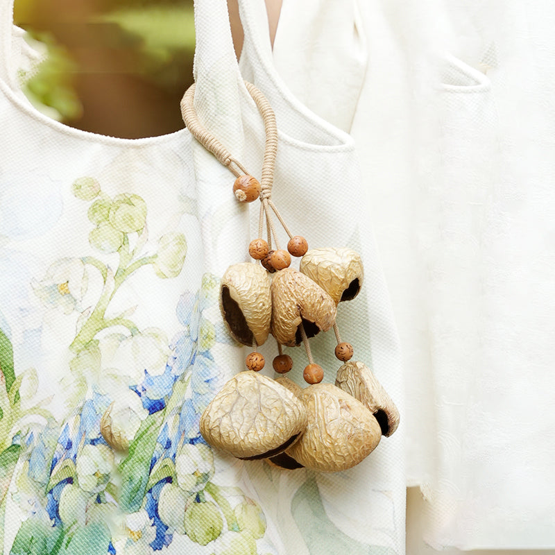 Pale natural seed pod accessory hanging on printed fabric tote | DIY Jade