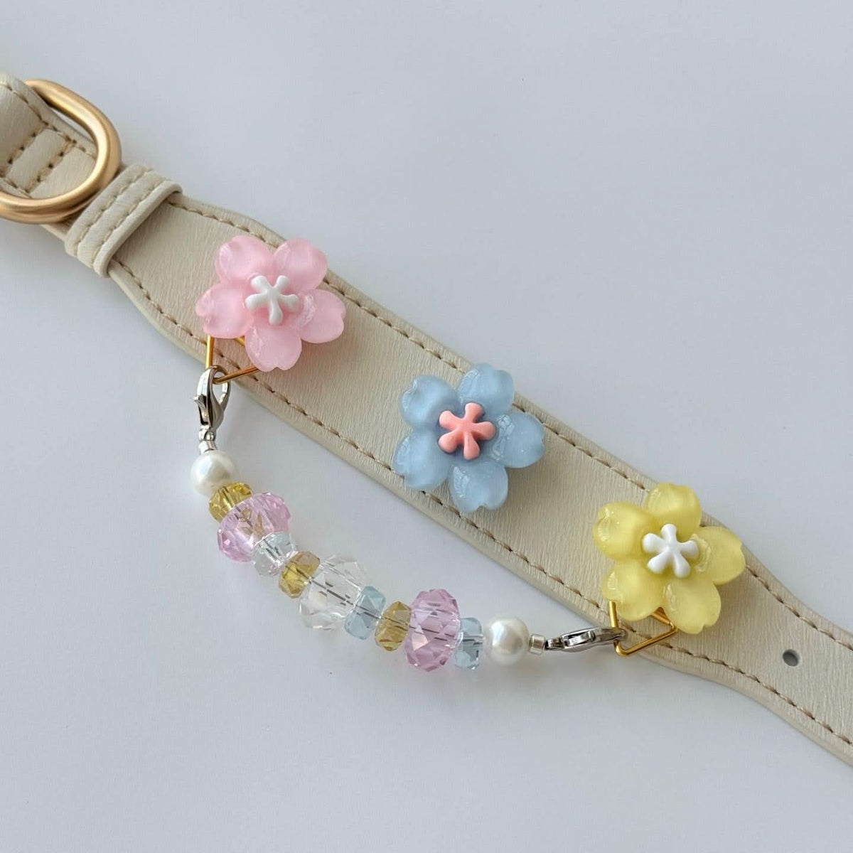 Pastel flower beaded cat collar displayed on a mannequin bust, front view | DIYJade