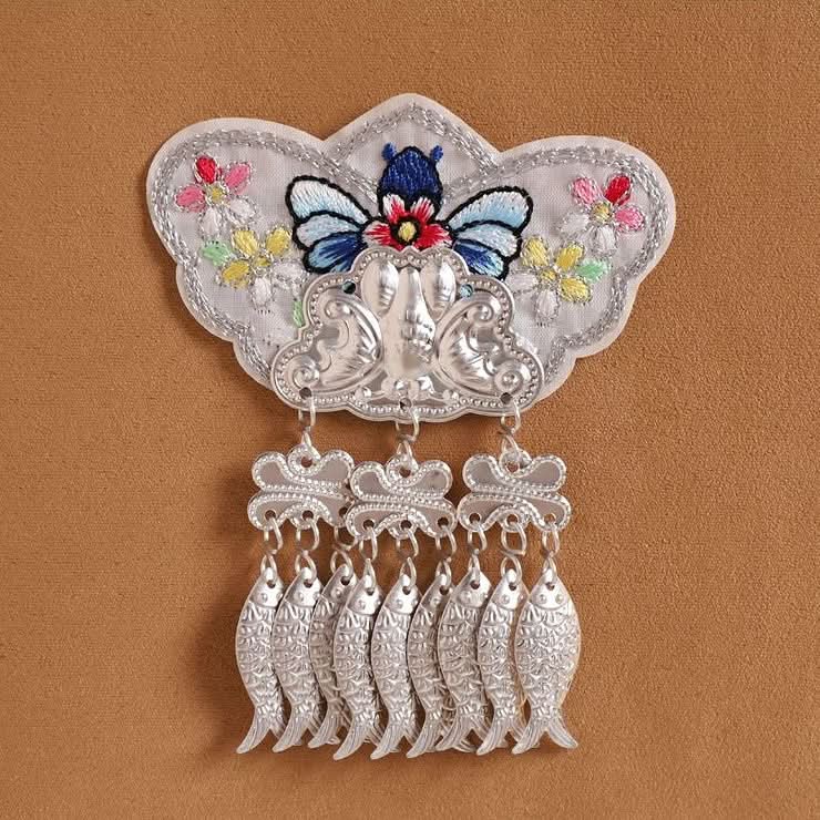 Soft‑hued butterfly applique, flower embroidery with thick silver fringe pendants
