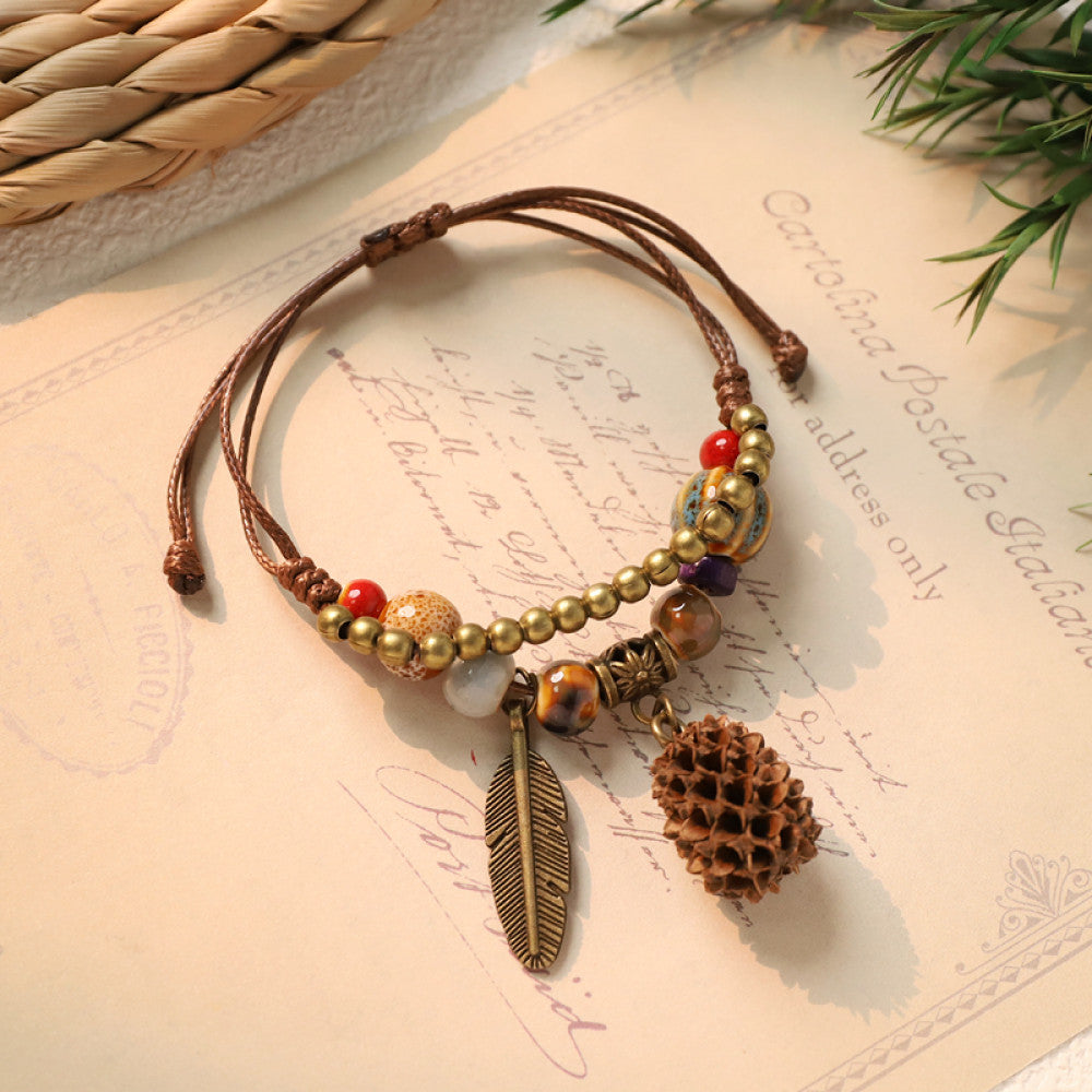 Woven boho bracelet with pinecone charm and feather pendant | DIY Jade
