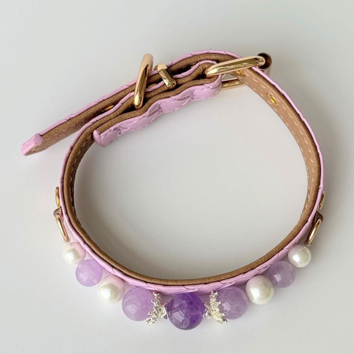 Overhead curved view pink quilted pet collar with purple stone and pearl beads | DIY Jade