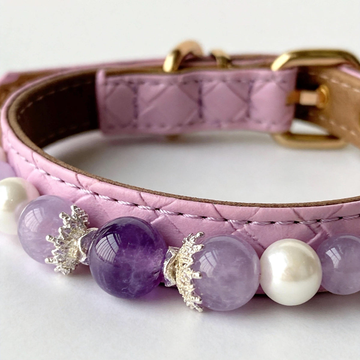 Close-up pink quilted faux leather pet collar with amethyst gem and white pearl beads | DIY Jade