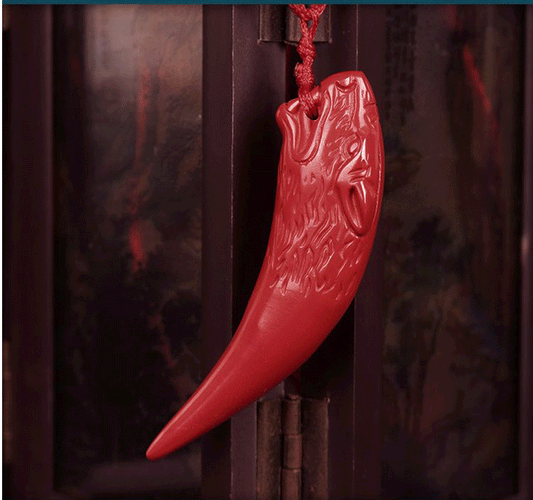 Red cinnabar wolf tooth pendant with carved wolf head design and red cord | DIY Jade