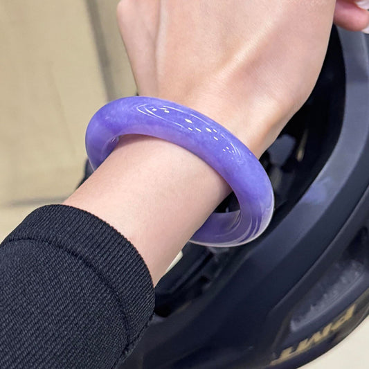 Rich vibrant purple jade bangle worn on wrist with black sweater, bold color statement jewelry | DIY Jade
