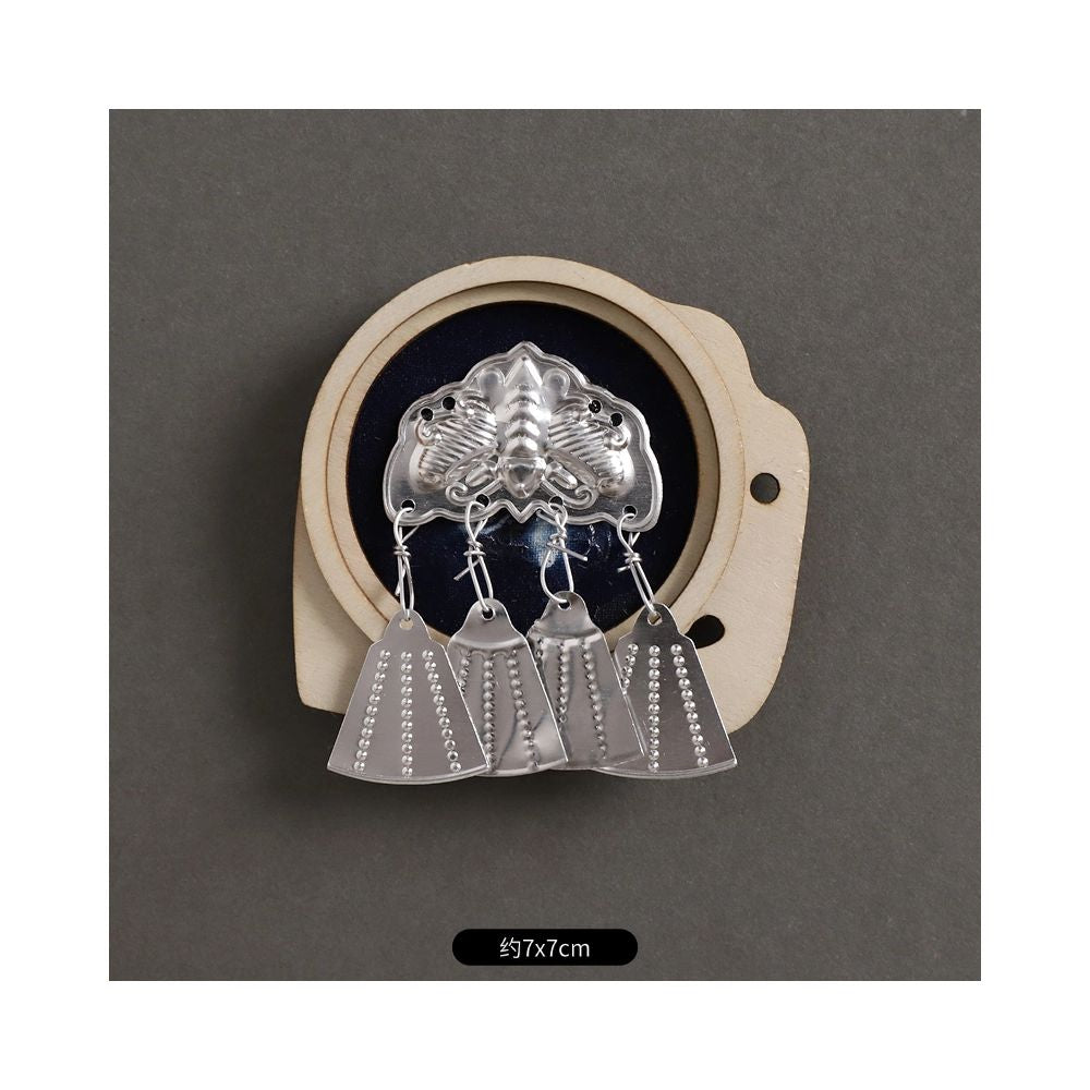 Round silver brooch with double hanging tassels