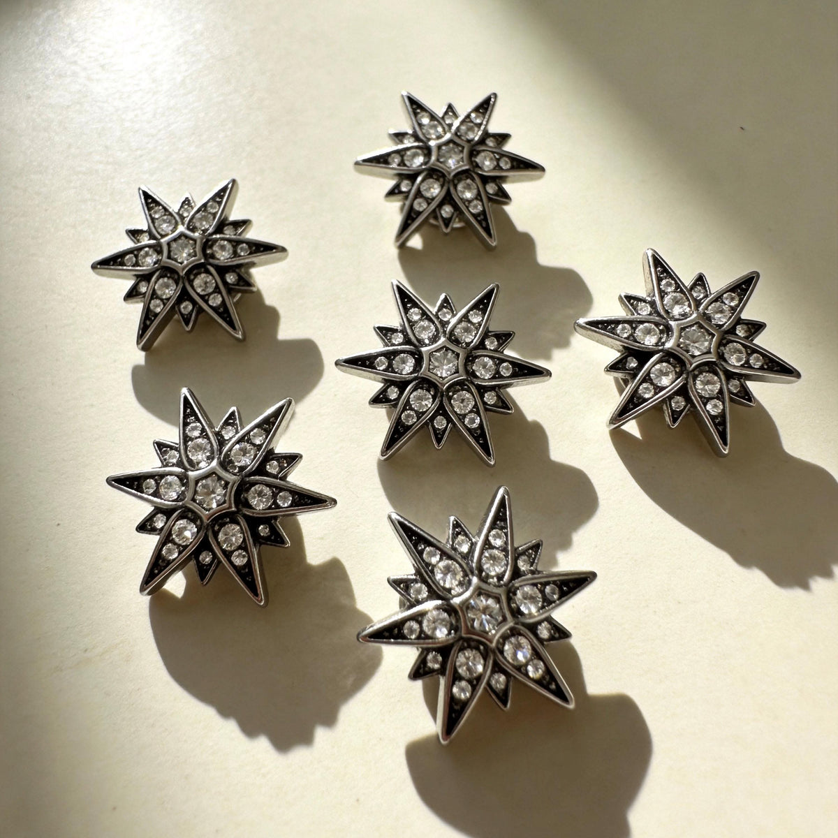Antique silver star‑burst crystal charms for pet collars flat lay product shot | DIY Jade