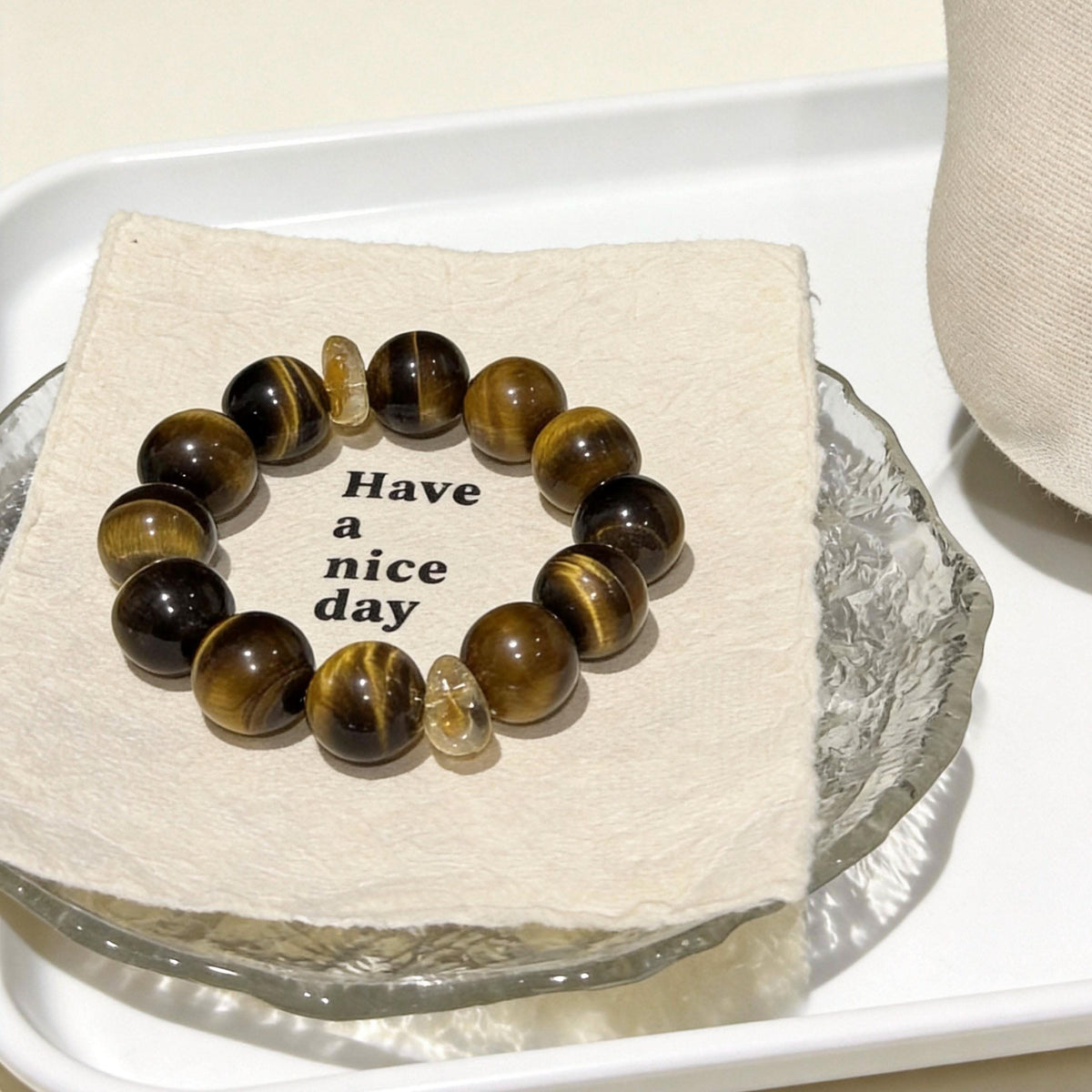  Natural tiger‑eye crystal bead bracelet presented on fabric‑glass tray | DIY Jade