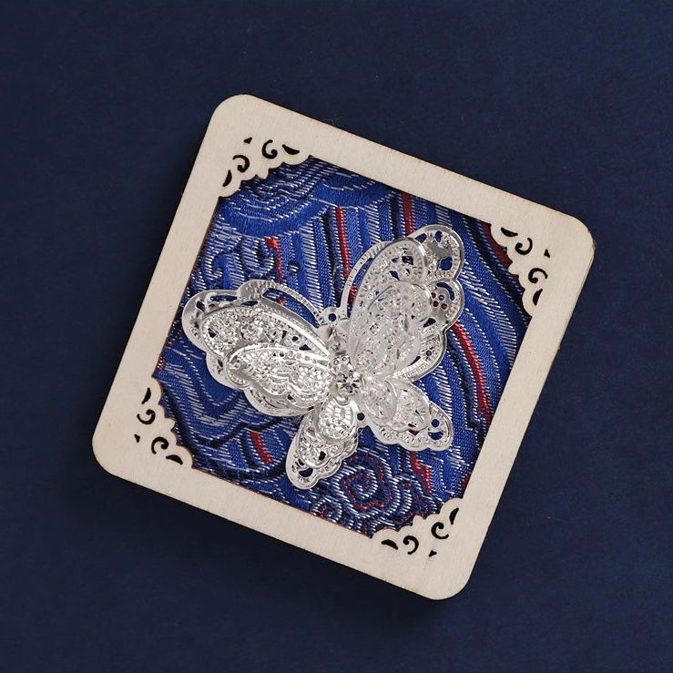 Rotated square fridge magnet, blue brocade fabric, silver butterfly applique folk souvenir