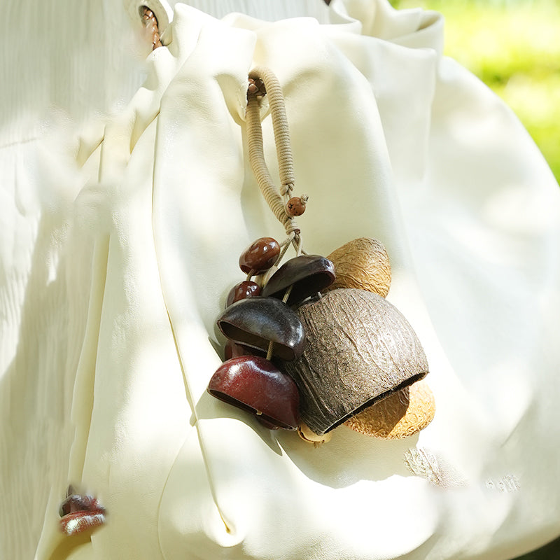Two‑tone seed pod charm attached to floral fabric shoulder bag | DIY Jade